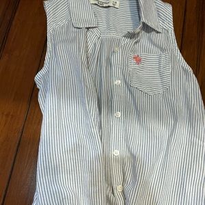 Sleeve less top with blue stripes.